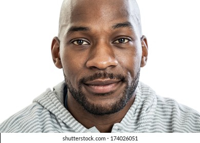 Head And Shoulders Close Up Portrait Of A Handsome Black Man In Late 20s With No Expression Isolated On White Background