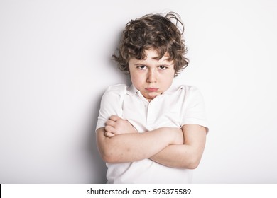 A Head and Shoulders Close Up Portrait of Young boy with Sulk attitude