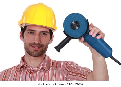 Head And Shoulders Portrait Of Craftsman Holding Tool