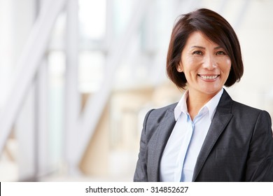 Head And Shoulders Portrait Of Smiling Asian Businesswoman