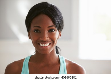 Head And Shoulders Portrait Of Smiling Young Black Woman