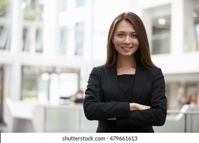 Head And Shoulders Portrait Of Young Businesswoman In Office