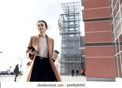 Head And Shoulders Slow Motion Portrait Of Beautiful And Confident Young Woman In Formal Suit Standing Outdoors, Looking At Camera And Smiling