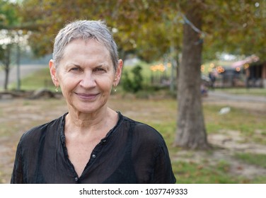 Head And Shoulders View Of Beautiful Older Woman With Short Grey Hair In Park (selective Focus)