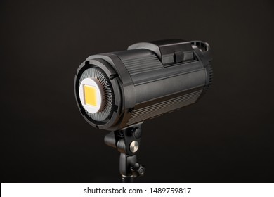 Head Of Studio Flash Strobe Lamp Light. Side View Professional Studio Photography Lighting Close Up On Black Background.