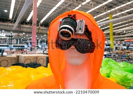 Head torch and an orange raincoat in a department store.