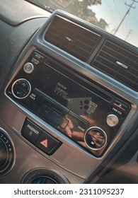 Head unit is a multimedia device installed on the dashboard of a car and used to control entertainment facilities in the car. This head unit is the brain of the car audio system. - Shutterstock ID 2311095237