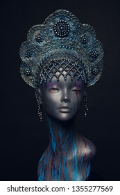 Head of woman mannequin in blue decorated kokoshnick, black studio background
