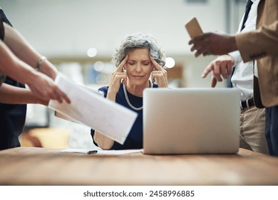 Headache, chaos and business woman in office with documents, report or admin crisis on laptop. Senior manager, boss or CEO with stress, overwhelmed and tired for multitasking or staff time management - Powered by Shutterstock