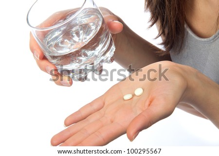 Headache hand with pills medicine tablets and glass of water against white background