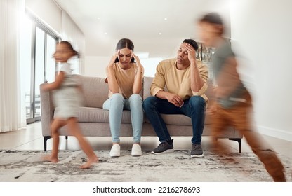 Headache, Noise And Stress With Family In Living Room And Parents Overwhelmed By Adhd Kids Energy. Tired, Burnout And Man, Woman And Hyper Active Children Running In House, Having Fun Or Playing Game