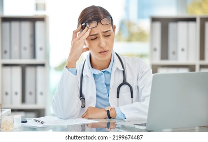 Headache stress, doctor burnout and sad nurse working on laptop in work office at hospital, tired from consulting in healthcare and anxiety from medical surgery. Worker with depression at clinic - Powered by Shutterstock