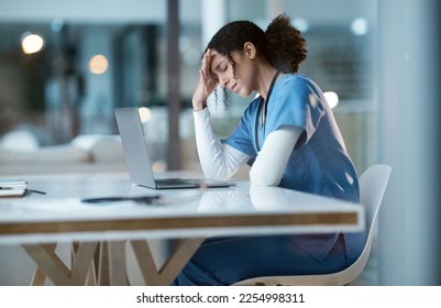 Headache stress, nurse and black woman in hospital feeling pain, tired or sick on night shift. Healthcare, wellness or female medical physician with depression or burnout while working late on laptop - Powered by Shutterstock