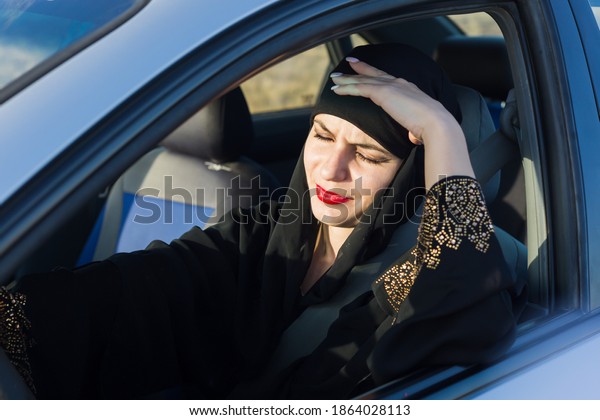 Headache in a woman\
driver sitting in a\
car.