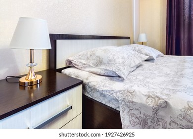 Headboard Of Wooden Bed In Modern Bedroom With Two Light Off Lamps On Nightstands On Both Sides.