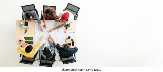 Header or banner of top view of creative diverse people. Overhead view of young creative team, start up colleagues group or college student meeting and voting agree opinion by pointing hands at desk.