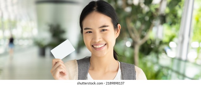 Header Crop Design Of Asian Female Student Holding Blank Credit Card, Concept Of Student Card, Student Loan, Scholarship Money, Educational Financial Credit