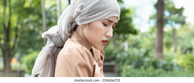 Header Crop Of Woman Cancer Patient Having Pain With Treatment Adverse Effect, Wearing Head Scarf Due To Post Chemotherapy Hair Loss And Painful Radiation Therapy Side Effect