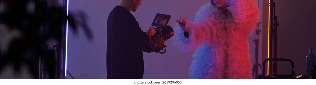 Header image of studio filming setup with woman performing in costume and cameraman recording during video shoot