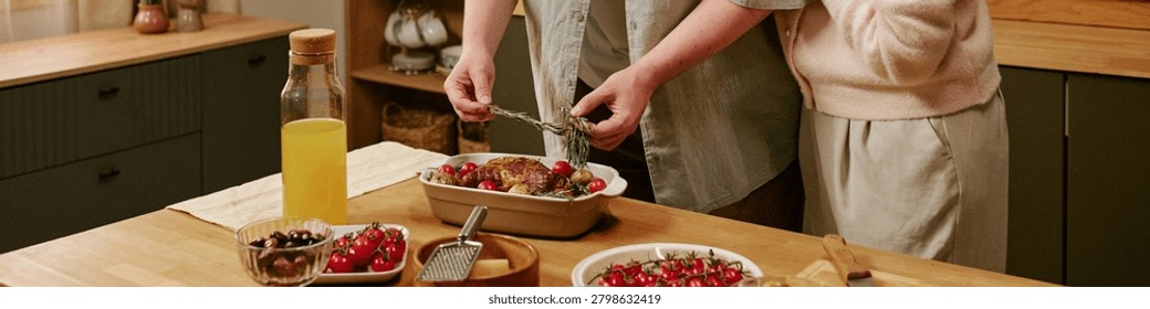 Header of unrecognizable hands serving Sunday lunch at home, presenting roasted meal for shared dining and weekend gathering. Ideal for family lifestyle, home cooking, togetherness marketing