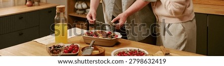 Header of unrecognizable hands serving Sunday lunch at home, presenting roasted meal for shared dining and weekend gathering. Ideal for family lifestyle, home cooking, togetherness marketing