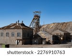 Headframe and buildings at old mining site in Broken Hill, NSW, Australia. This area of Broken Hill is where the mining company BHP was founded in 1885. They mined silver, lead and zinc.