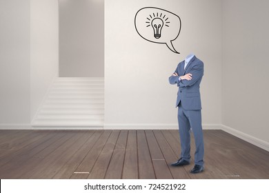Headless businessman with arms crossed against empty room - Shutterstock ID 724521922