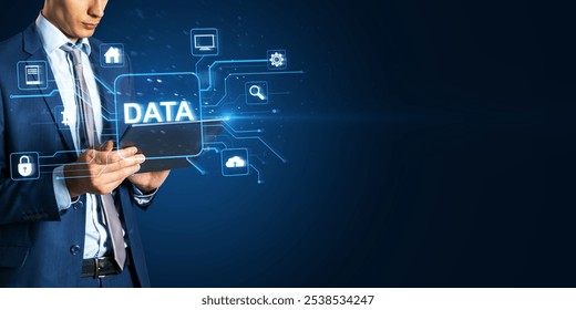 Headless young man using digital pad with glowing data hologram on blue background with mock up place. Big data, Application programming interface concept