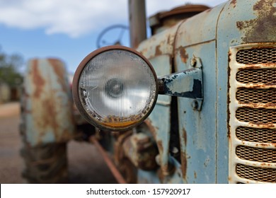 The Headlight Of Abandoned Rusty Vintage Tractor. Small Depth Of Field