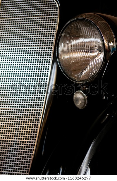 The
headlight of an antique, rarity, vintage black
car.