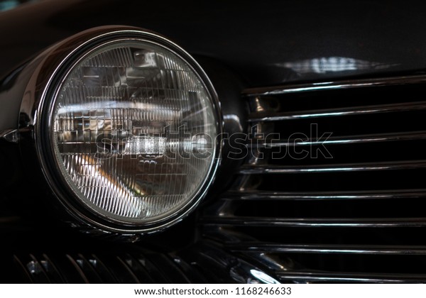 The\
headlight of an antique, rarity, vintage black\
car.