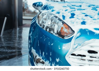 Headlight Of A Blue Man In Foam From Car Shampoo