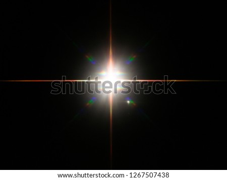 Headlight or camera flash on a dark reflective background reveals vivid colorful star burst.