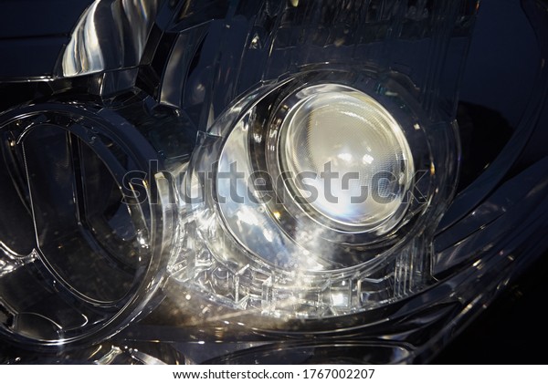 The headlight of the car, turned on the light
on the background of a dark
night