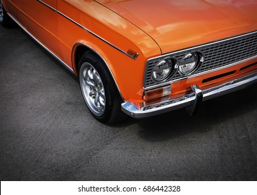 Headlight closeup from retro orange car. old car on the road - Powered by Shutterstock