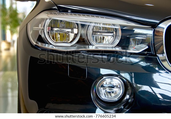Headlight. Front Car detail. The front lights of the\
luxury car.