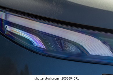 Headlight Lamp Of New Car. Close Up Detail On One Of The LED Headlights Modern Black Car. Exterior Closeup Detail. Closeup Headlights Of Car.