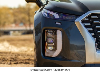 Headlight Lamp Of New Car. Close Up Detail On One Of The LED Headlights Modern Black Car. Exterior Closeup Detail. Closeup Headlights Of Car.