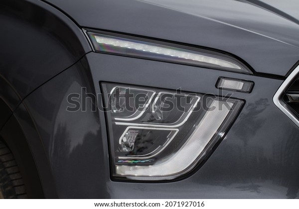 Headlight lamp of new cars. Close up detail on one\
of the LED headlights modern car. Exterior closeup detail. Closeup\
headlights of car.