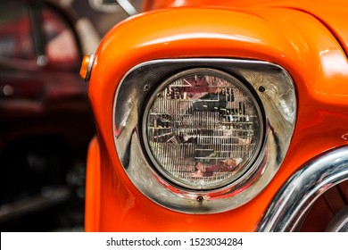 Headlight lamp vintage car. Classic car headlight. Close-up of headlights of orange vintage car. Exhibition. - Powered by Shutterstock