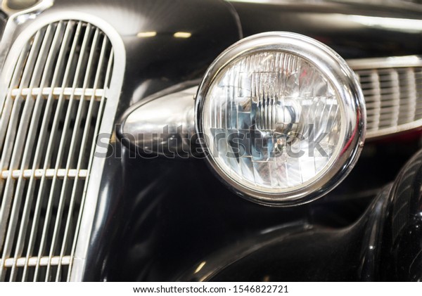 Headlight lamp\
vintage car. Headlight lamp vintage classic car. Front part with\
the headlight retro car\
closeup.