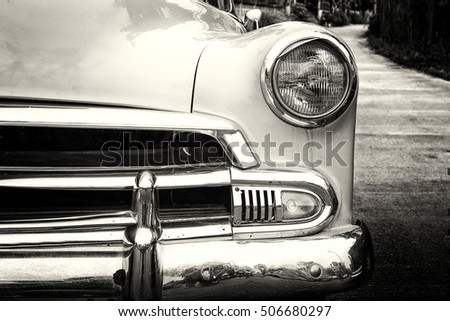headlight lamp vintage classic car parked,  black and white vintage film grain filter effect styles