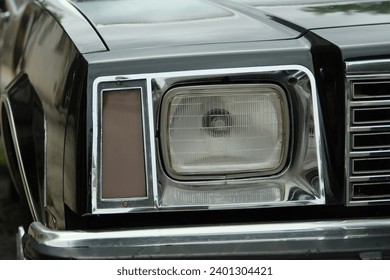 Headlight of an old Buick police patrol car, daytime close-up photo, without people, Buenos Aires, Argentina