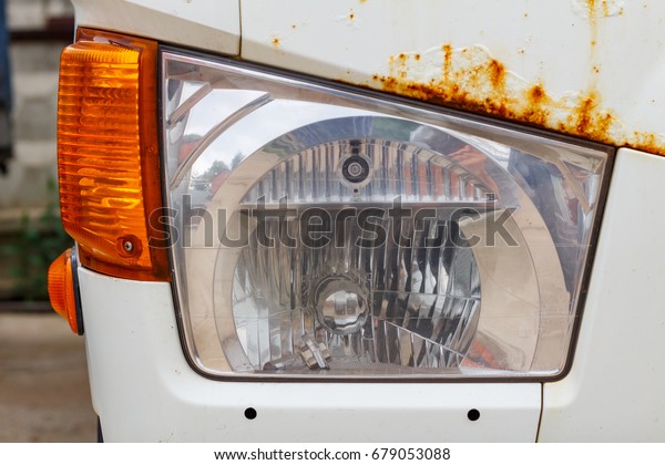Headlight of a old\
truck closeup. Front\
view
