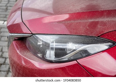 Headlight Of A Red Dirty Car Side View On Parts Of The Car In A Layer Of Dry Dust Close-up, Nobody.