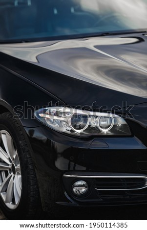 Headlights of black sports car