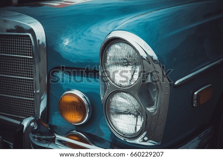 Headlights and body of an old classic car at an exhibition of vintage cars