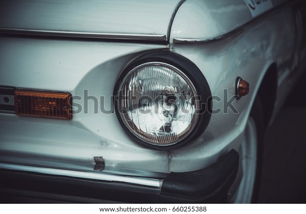 Headlights and body of an old classic car at an\
exhibition of vintage\
cars