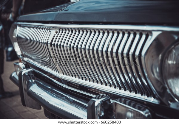 Headlights and body of an old classic car at an\
exhibition of vintage\
cars