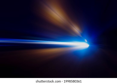 The headlights of the car at night make it a beautiful laser light. - Shutterstock ID 1998580361